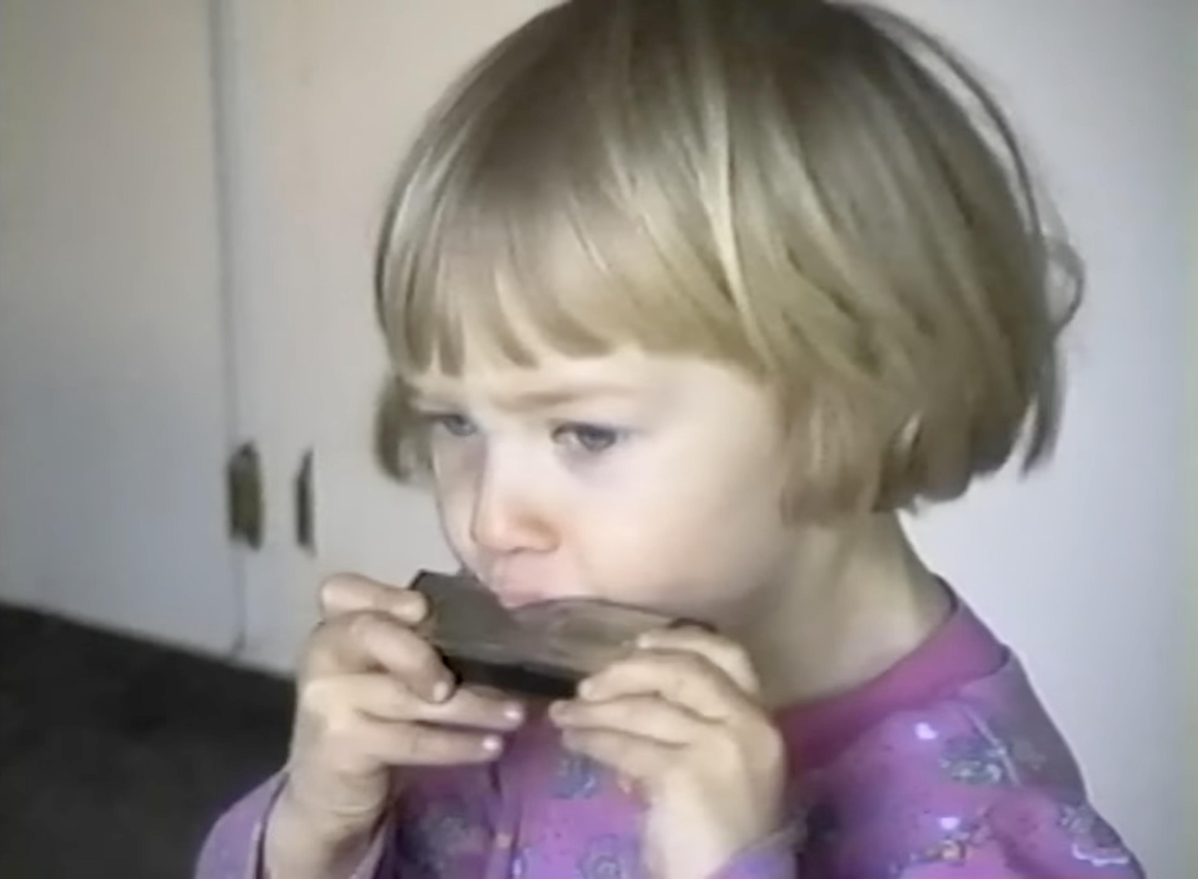 Toddler Akiane playing a harmonica
