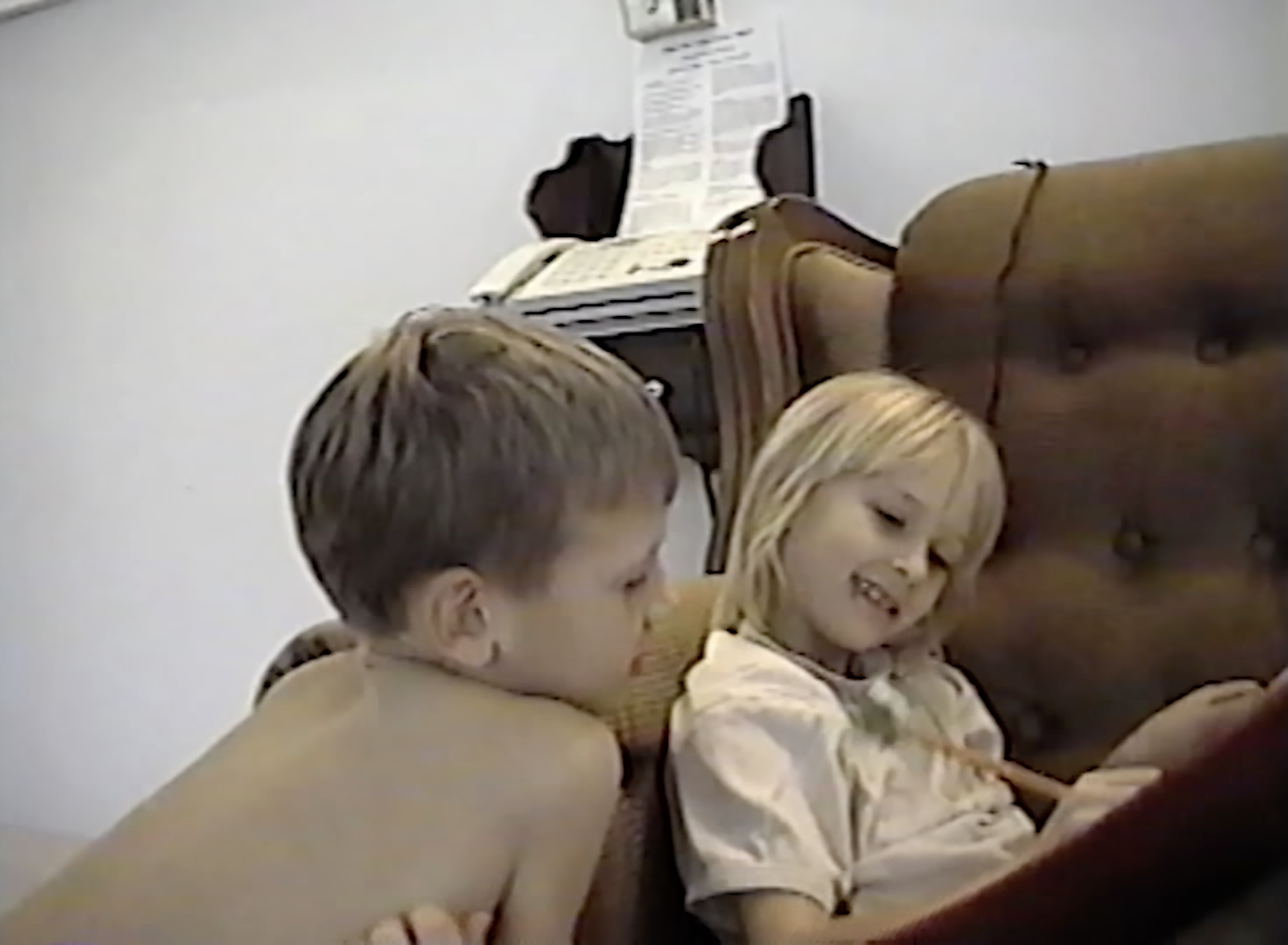 Akiane laughing beside one of her older brothers in an armchair