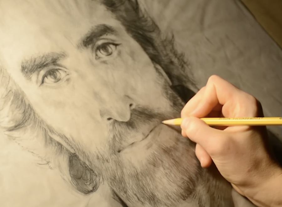 Close-up of a detailed pencil drawing of a bearded face