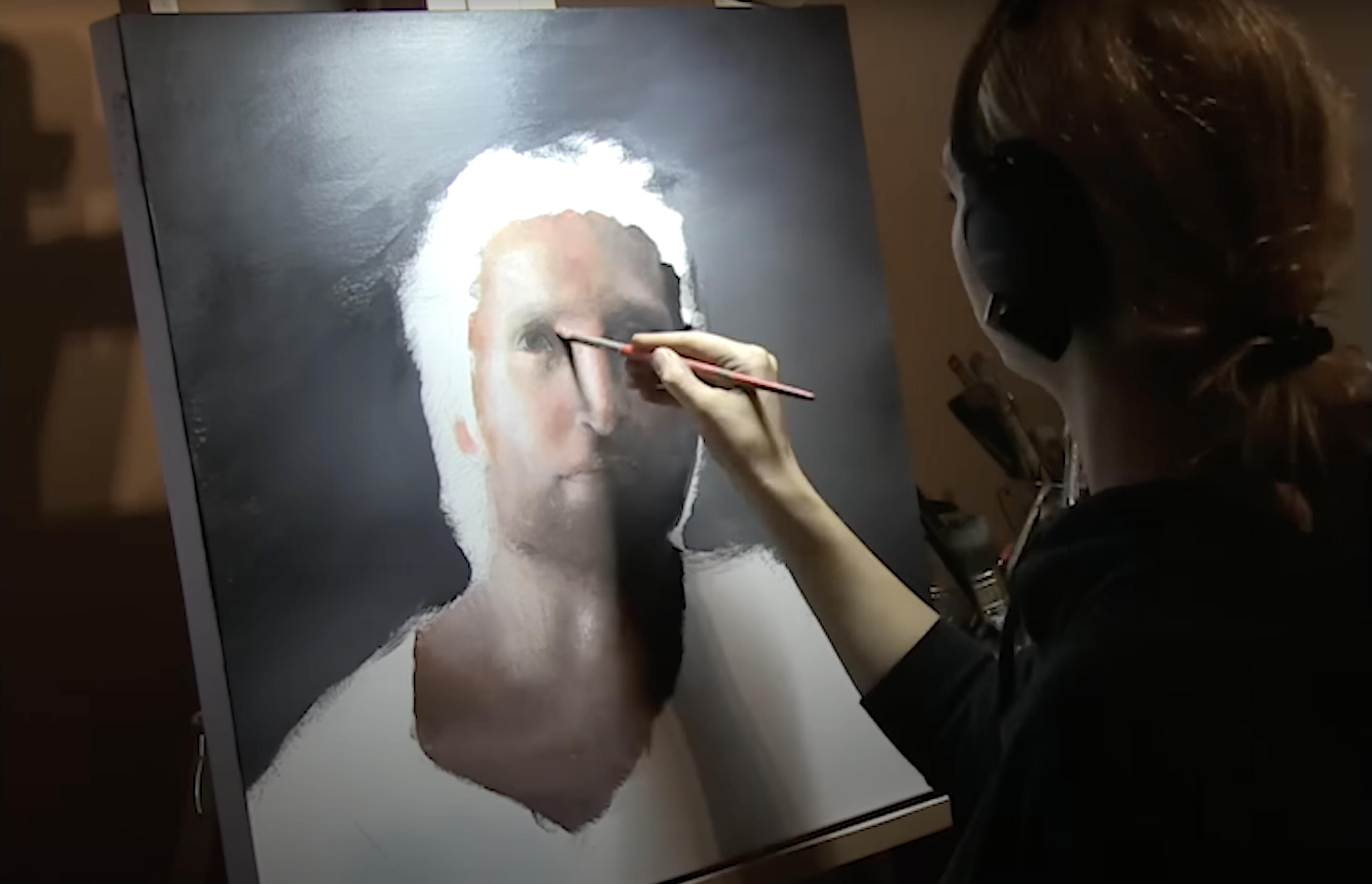 The underpainting of a face, light side only, with Akiane painting